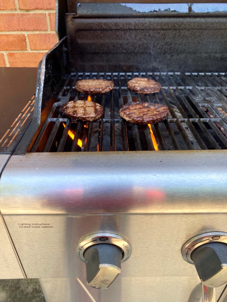 burgers cooking on the grill