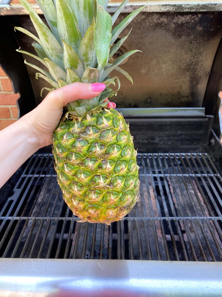 hand holding pineapple