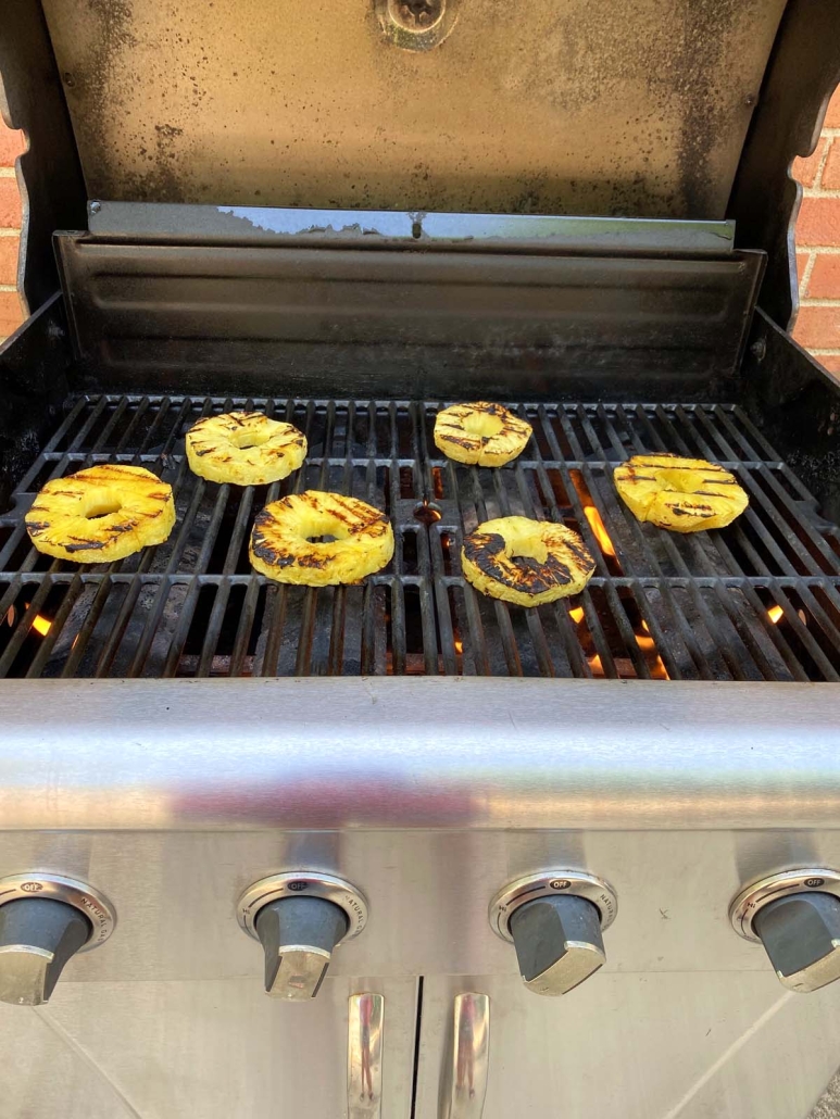 pineapple slices cooking on the grill 
