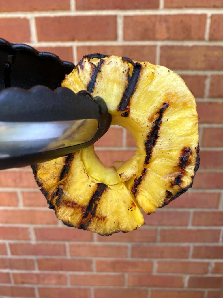 tongs holding Grilled Pineapple Slice