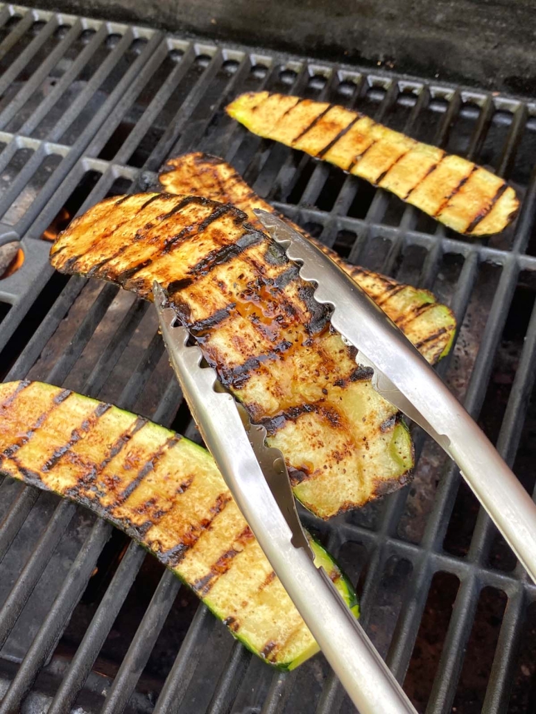 tongs holding Grilled Balsamic Zucchini Slice