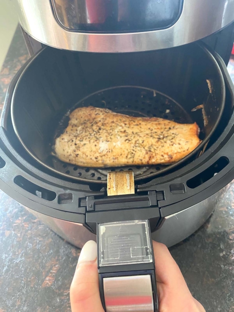 air fryer opened to show easy recipe rainbow trout inside