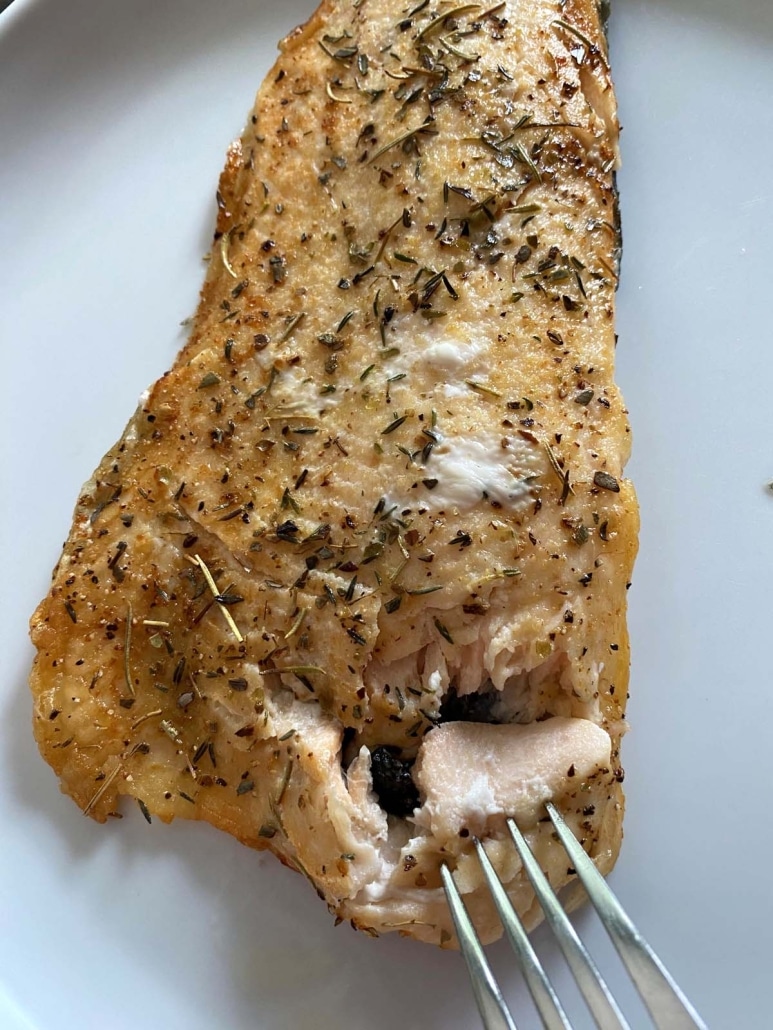 fork flaking fillet of rainbow trout