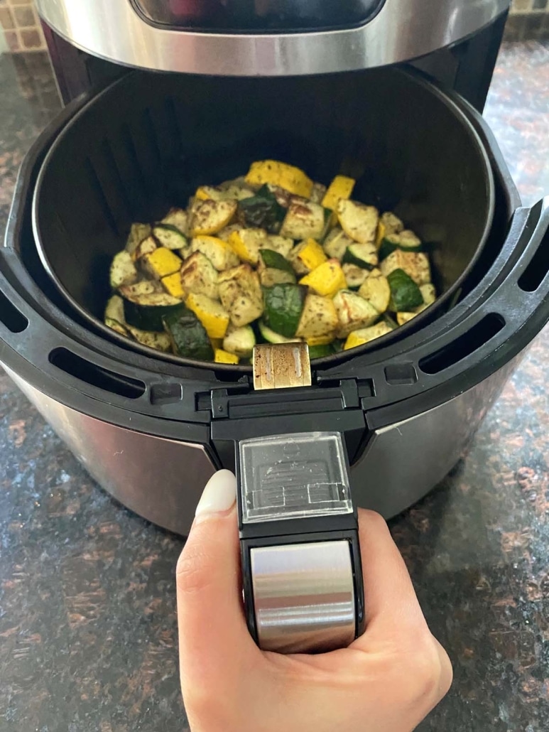 air fryer opened to show zucchini and squash inside