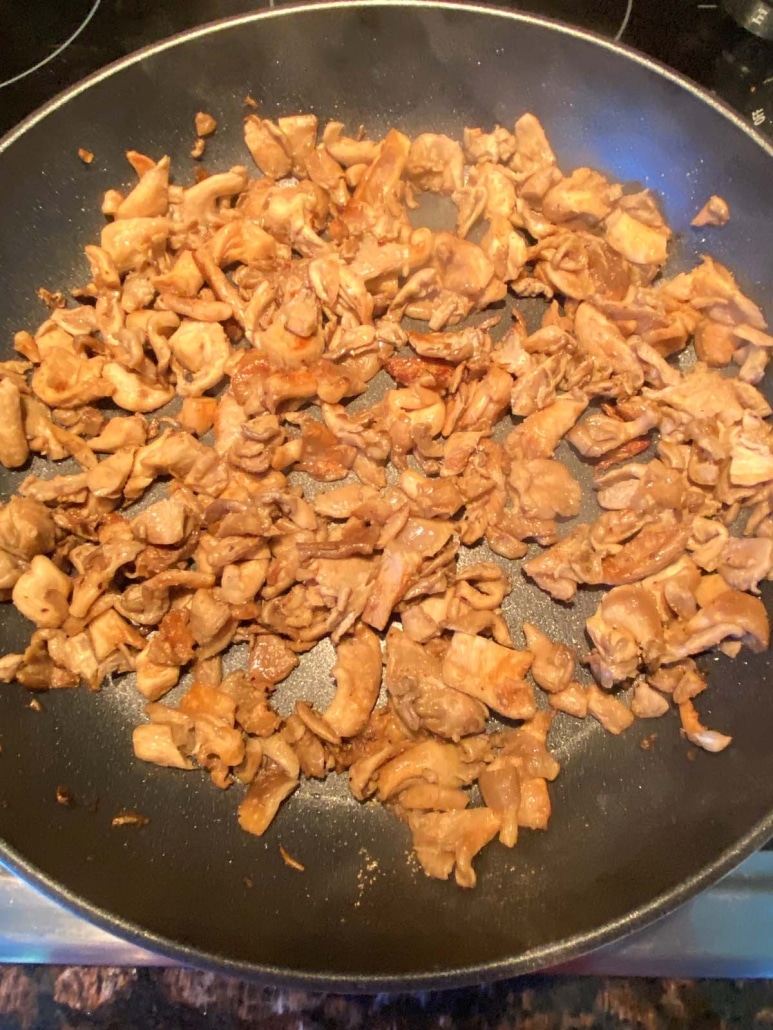 chopped oyster mushrooms cooked in a pan