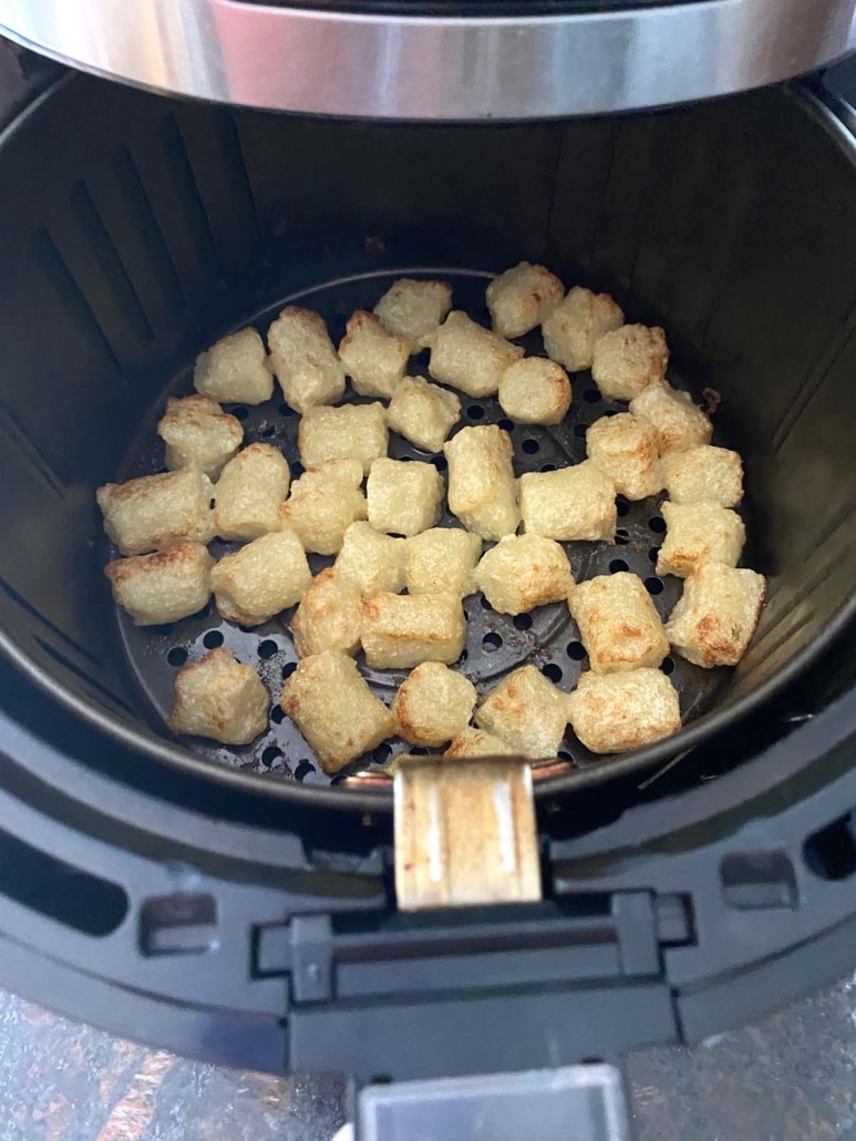 air fryer opened to show Trader Joe’s Cauliflower Gnocchi roasting inside