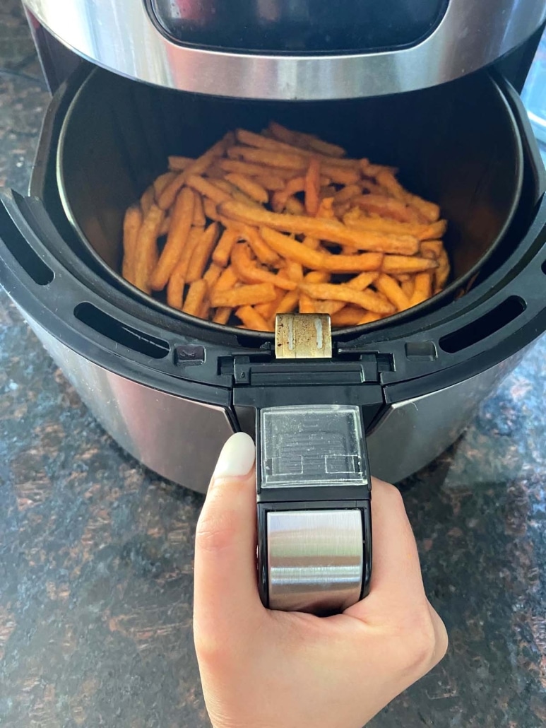 air fryer opened to show cooking fries