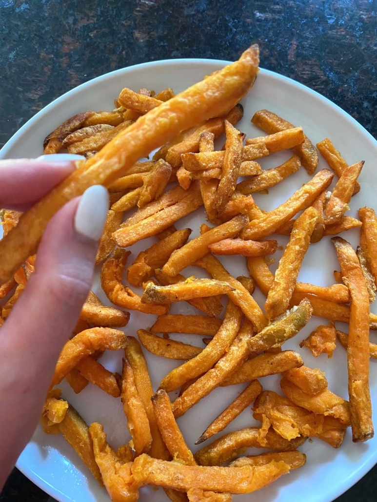 hand holding Trader Joe’s Sweet Potato Fry