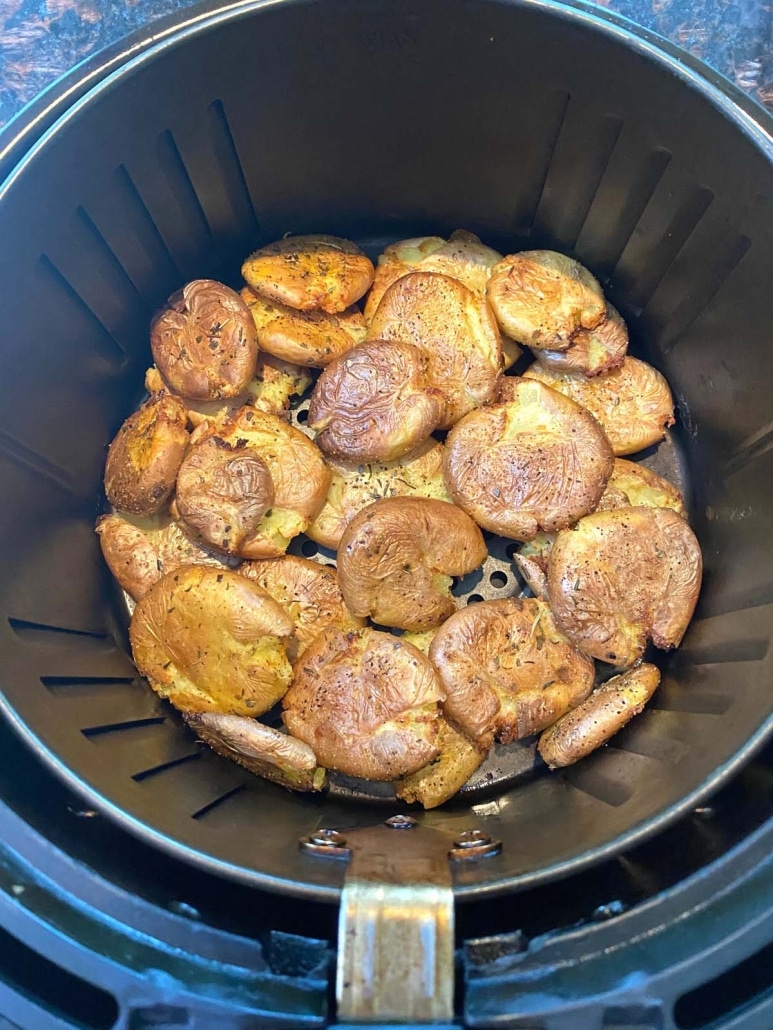 air fryer filled with smashed potatoes