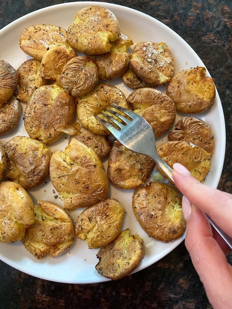 fork piercing tender smashed potatoes