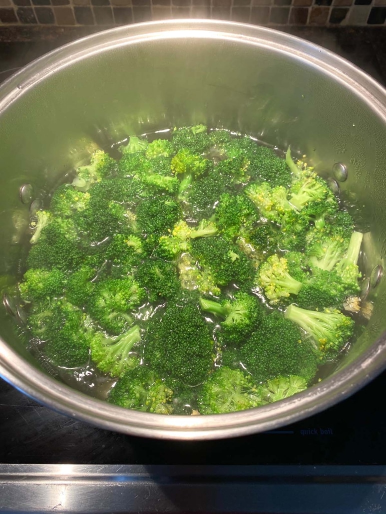 broccoli florets boiling in a pot of water