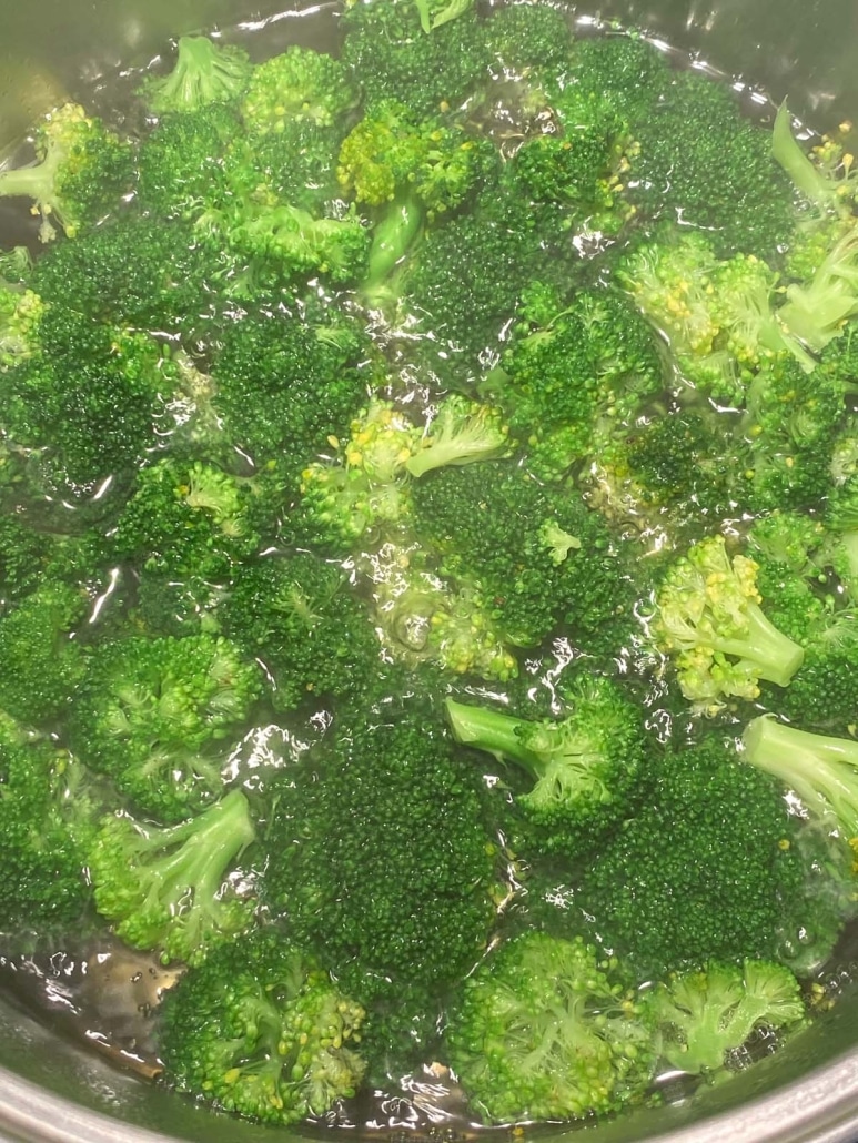 vibrant green broccoli in a pot of water