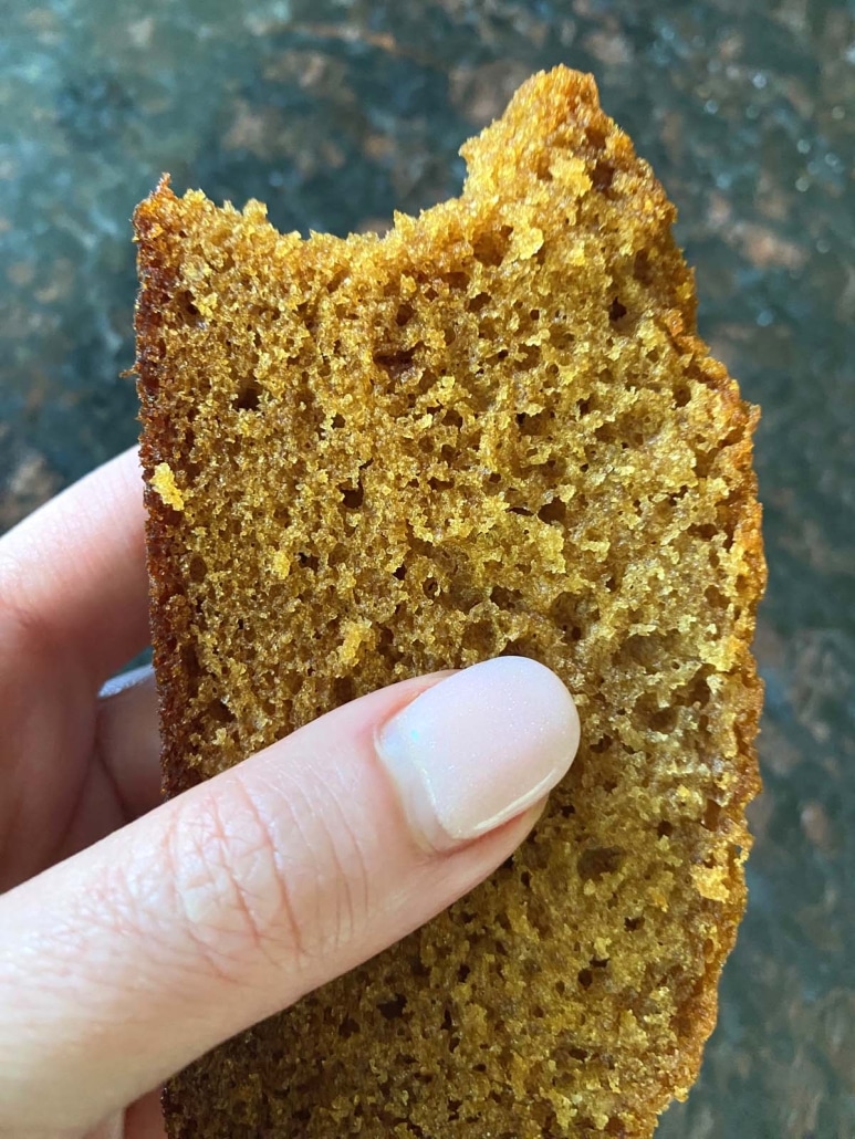 hand holding slice of Honey Cake with bite taken out