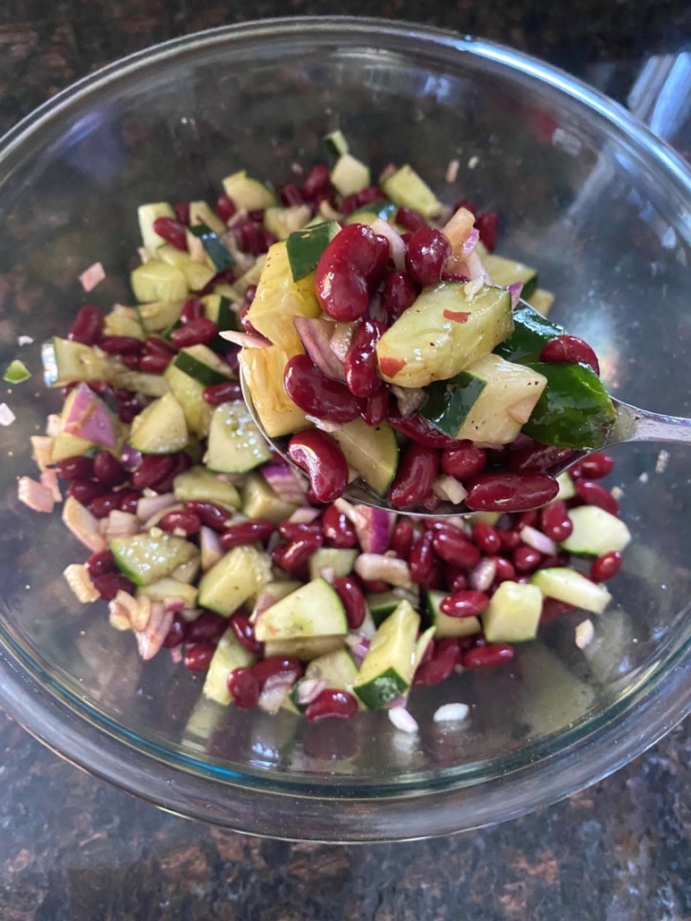 stirring up the ingredients for Kidney Bean Salad