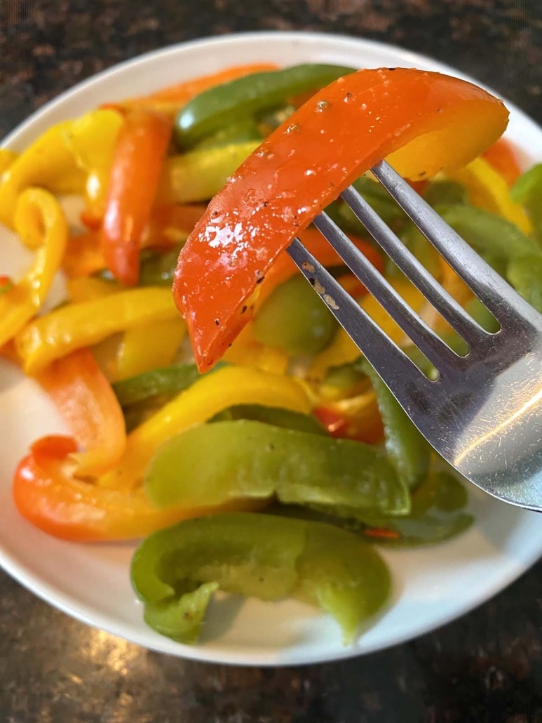 fork holding a slice of cooked bell pepper