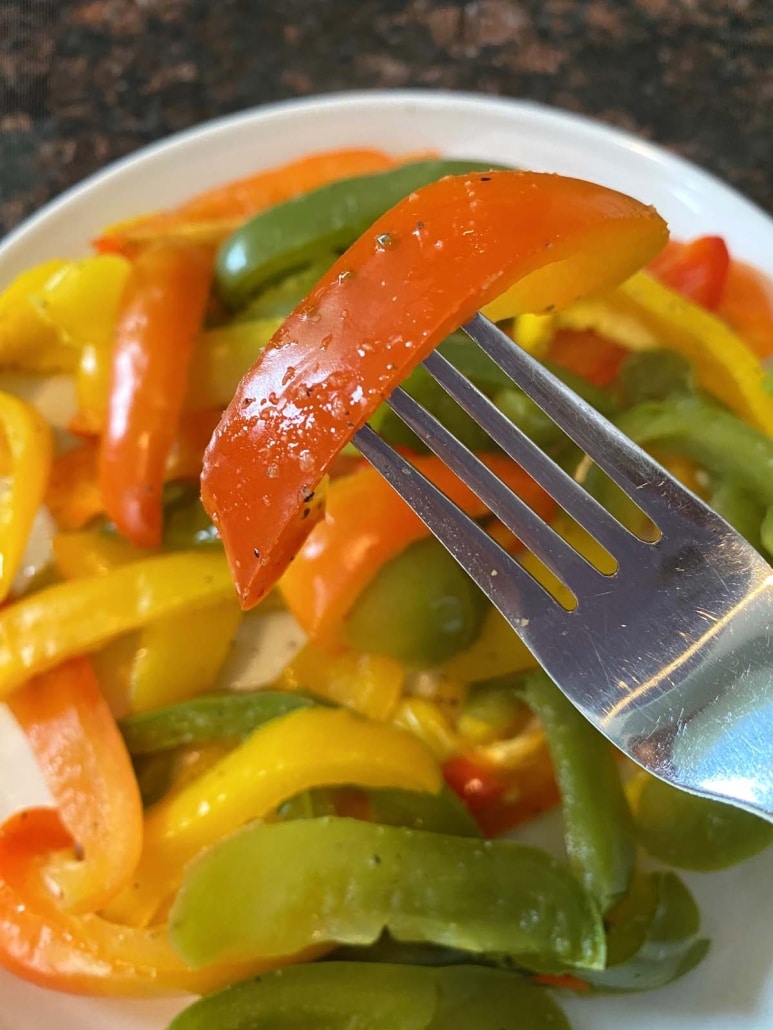 fork holding piece of seasoned and cook bell pepper strip