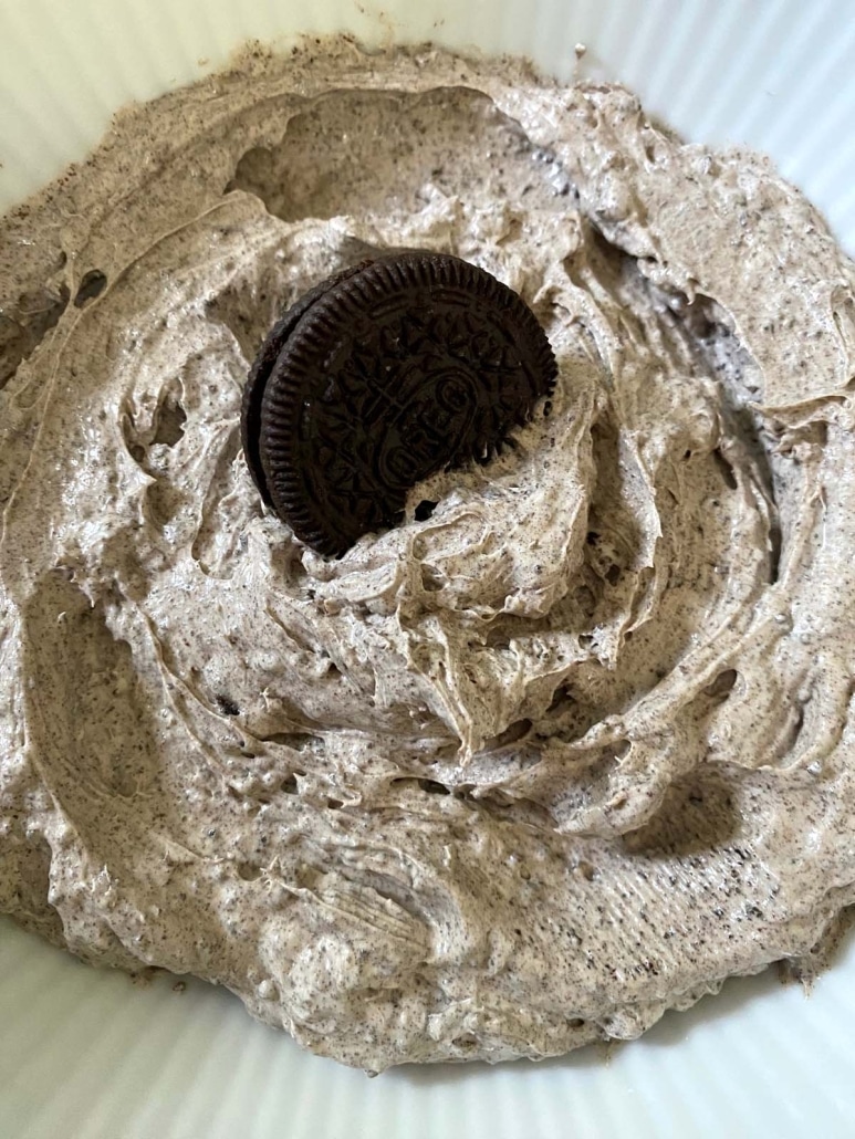 scooping up Oreo Dip with an Oreo cookie