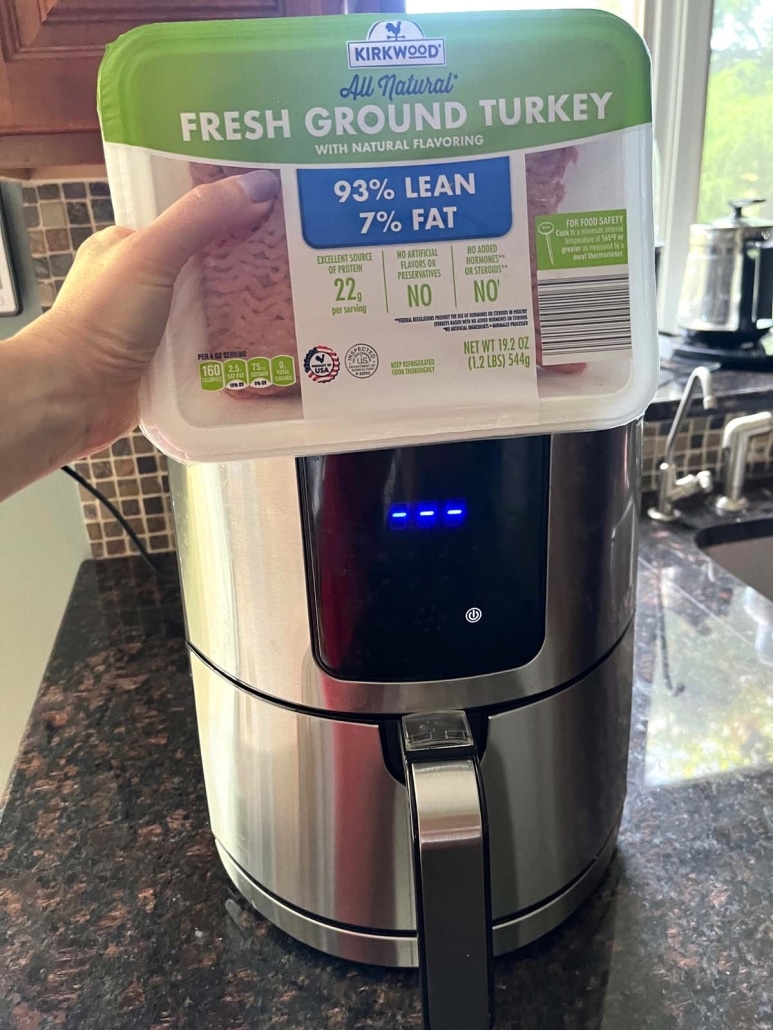 package of ground turkey in front of an air fryer