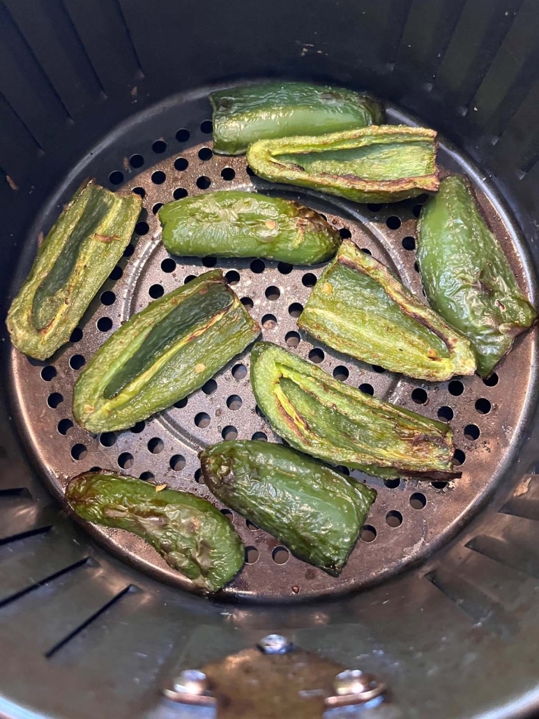 sliced and seasoned jalapeños in an air fryer