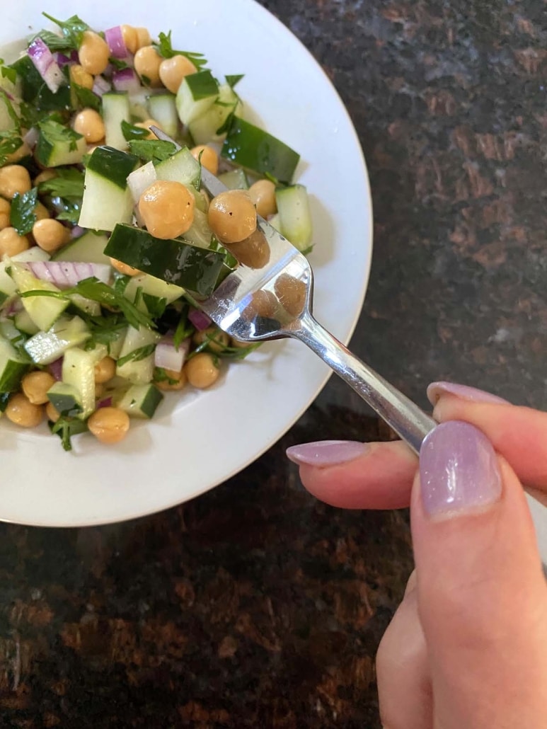 hand picking up a bite of Cucumber Chickpea Salad