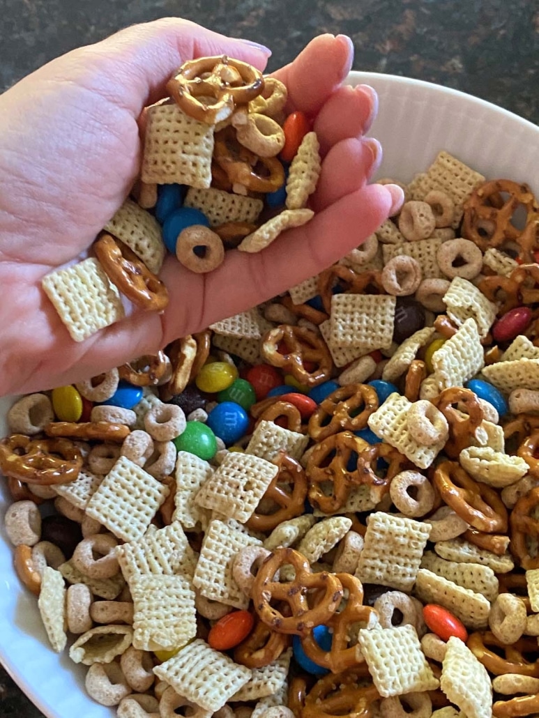 hand holding serving of easiest Homemade Chex Mix recipe