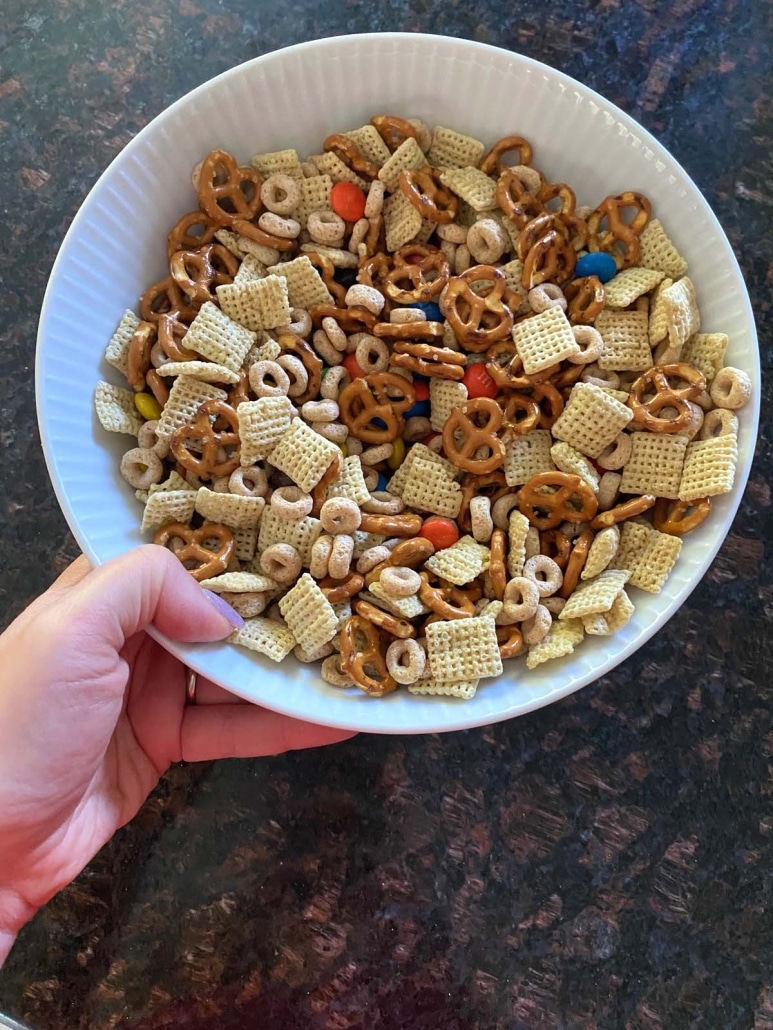 hand holding bowl with easy snack Homemade Chex Mix