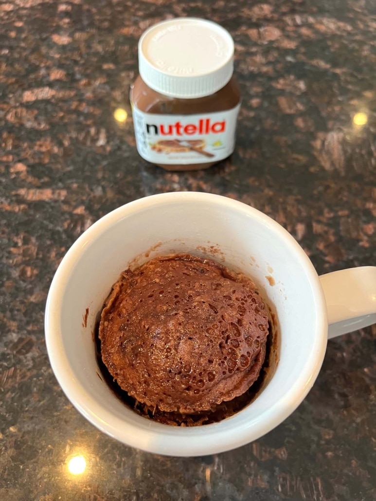 Nutella Mug Cake next to a container of Nutella