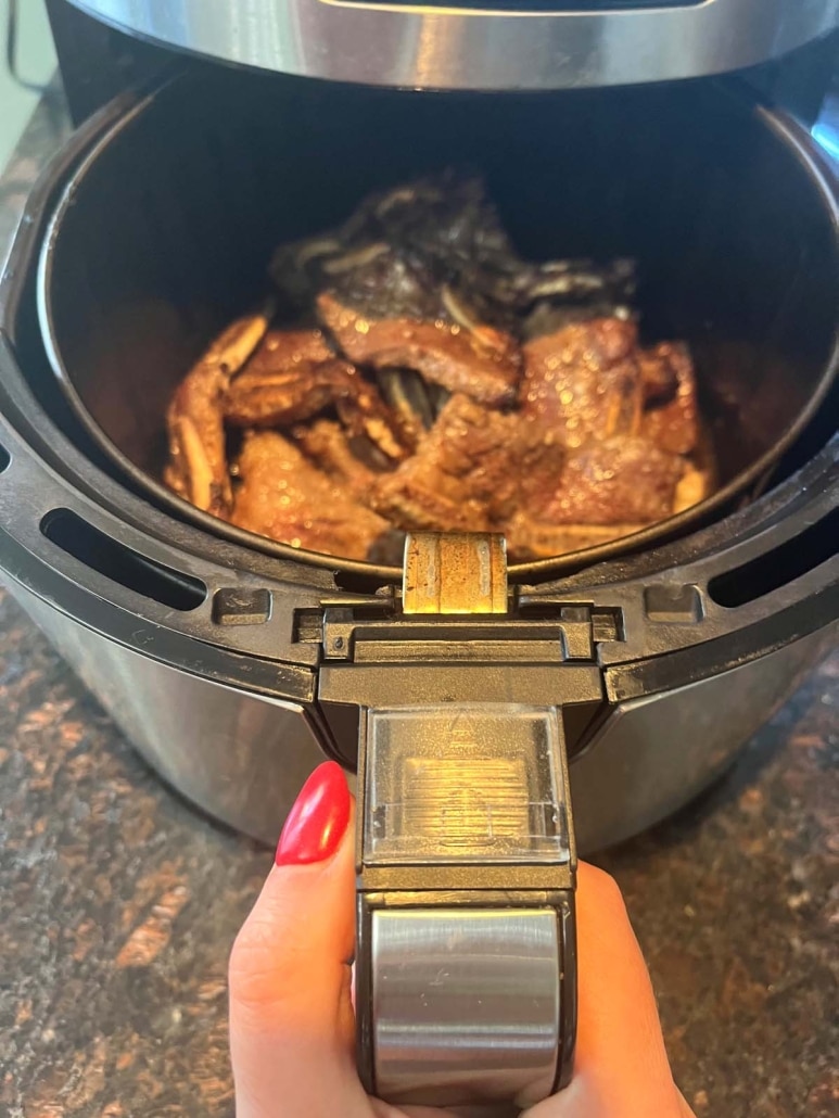 air fryer opened to show finished beef short ribs