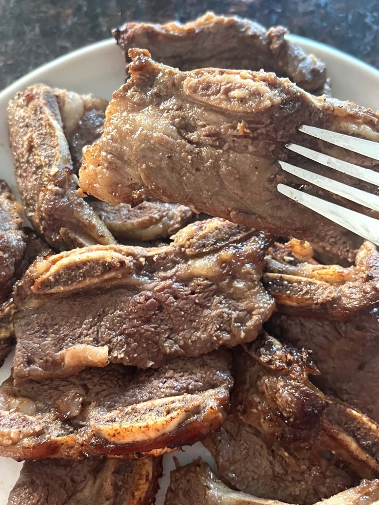 fork holding piece of seasoned beef short rib