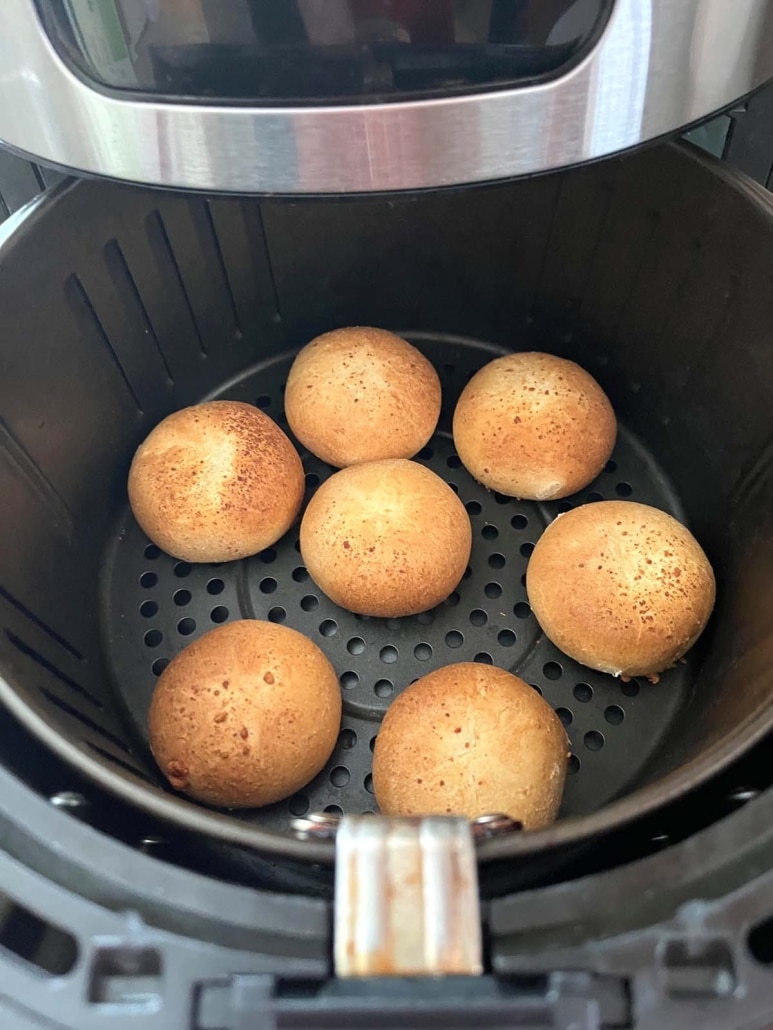 air fryer opened to show mozzarella bites heating up inside