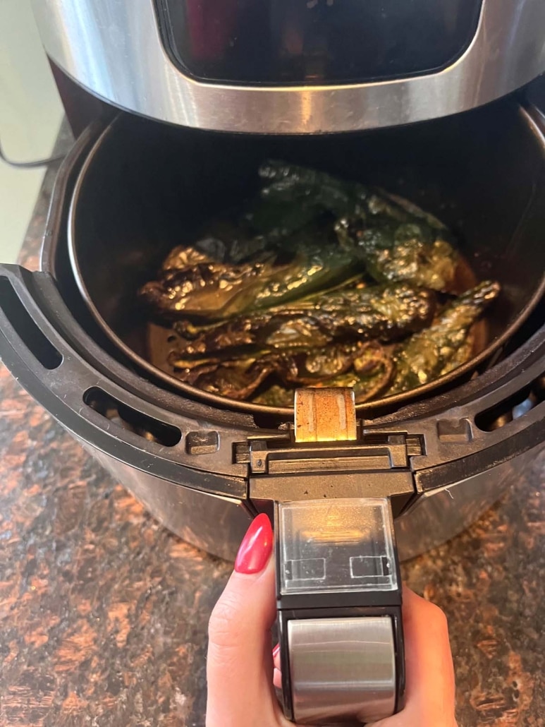 air fryer opened to show roasted poblano peppers inside