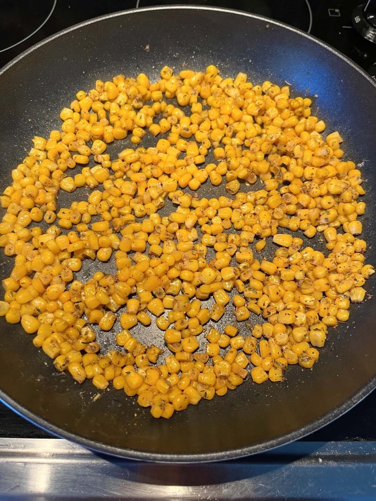 seasoned corn cooking in skillet