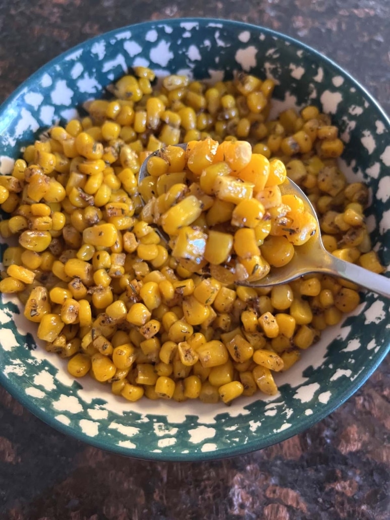 bowl of cooked, canned corn with spoon