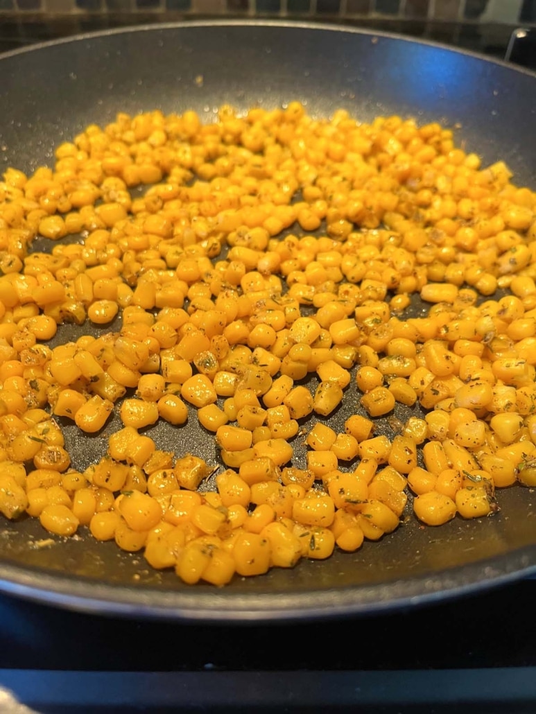 heated corn kernels in a skillet