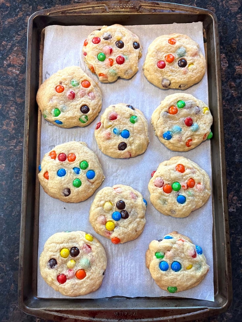 bakery style M&M Cookies on a cookie sheet