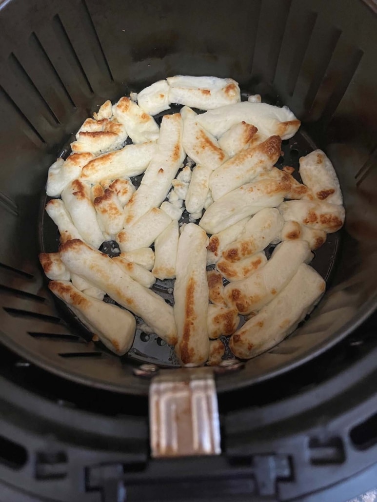 Aldi cheese fries cooked in an air fryer basket