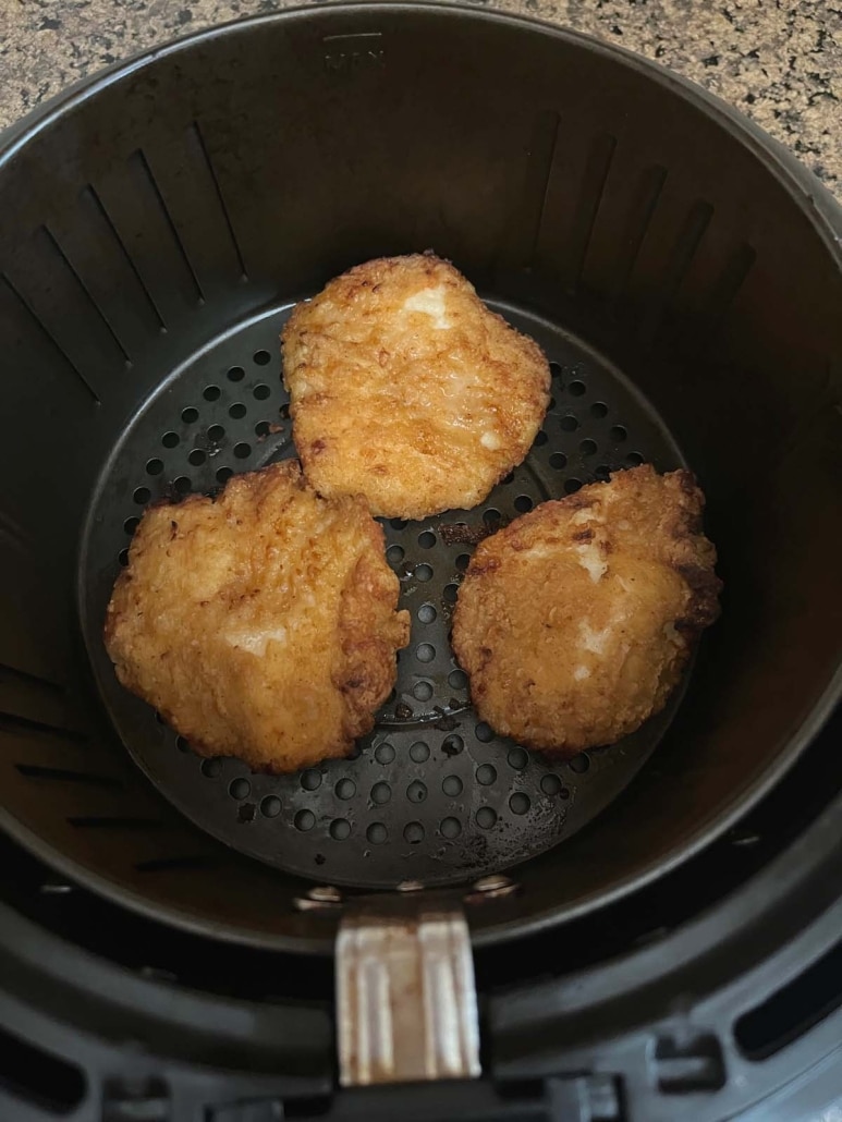 breaded chicken pieces in air fryer basket
