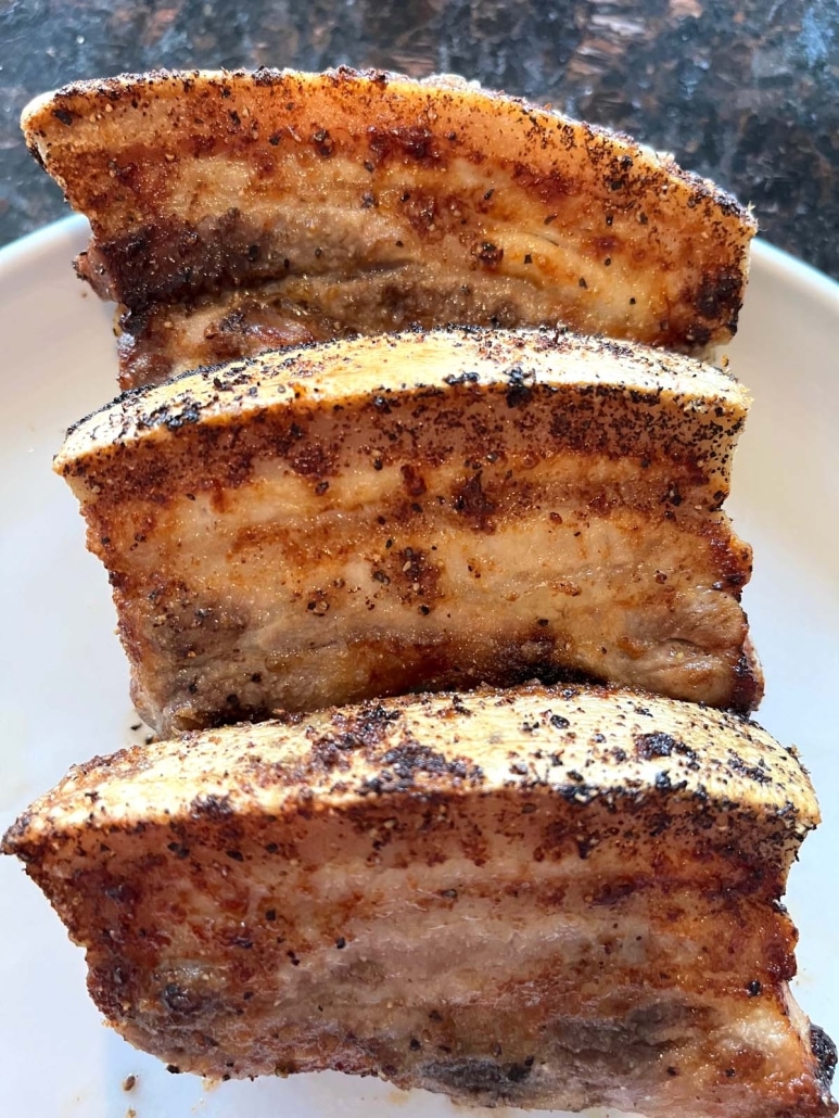 slices of pork belly on a plate