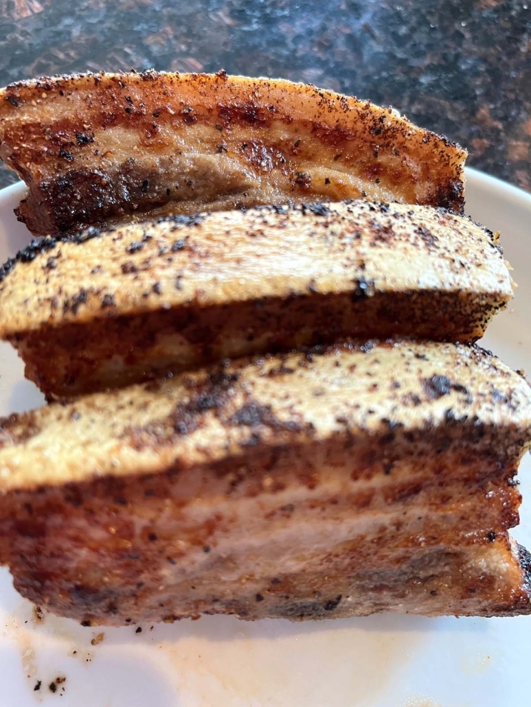 seasoned slices of pork belly on a plate