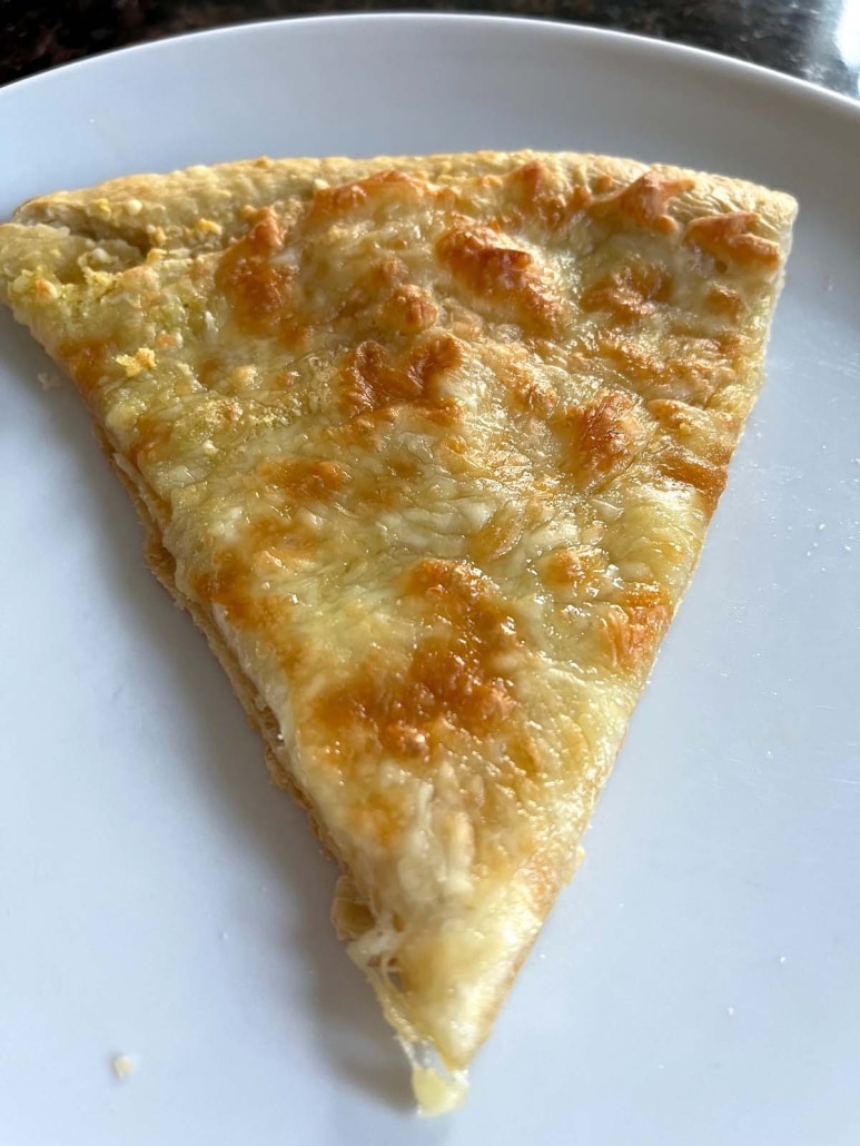 slice of cheesy Garlic Pizza on a plate