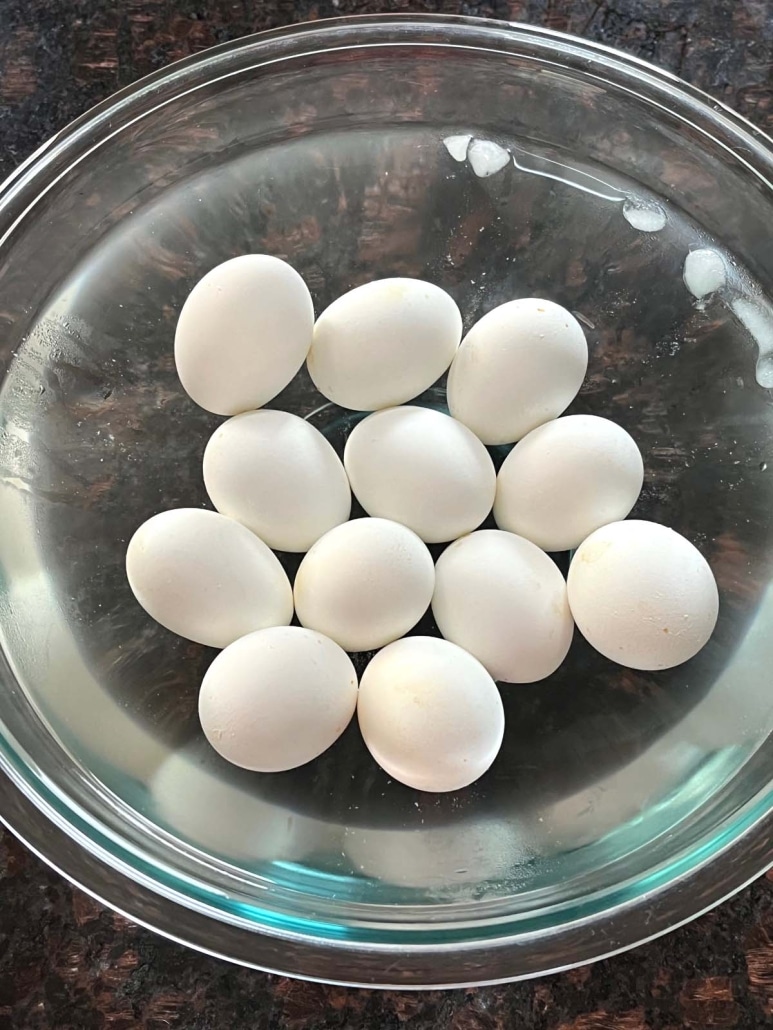 batch of hard boiled eggs in a bowl of ice water