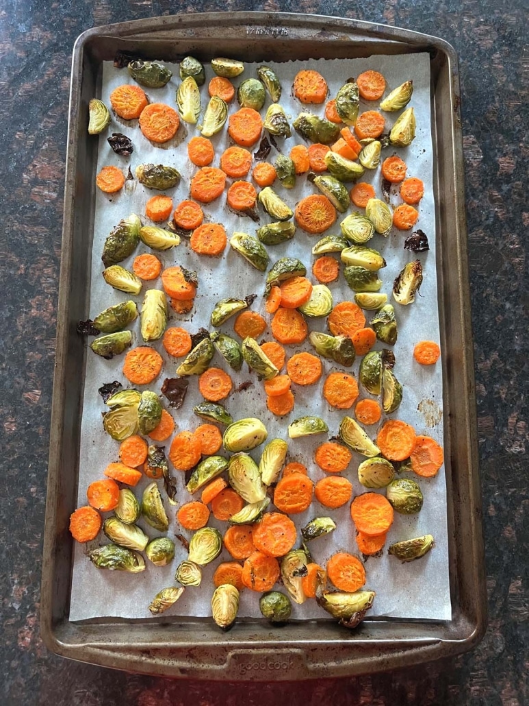 parchment paper-lined baking sheet with Roasted Brussels Sprouts And Carrots