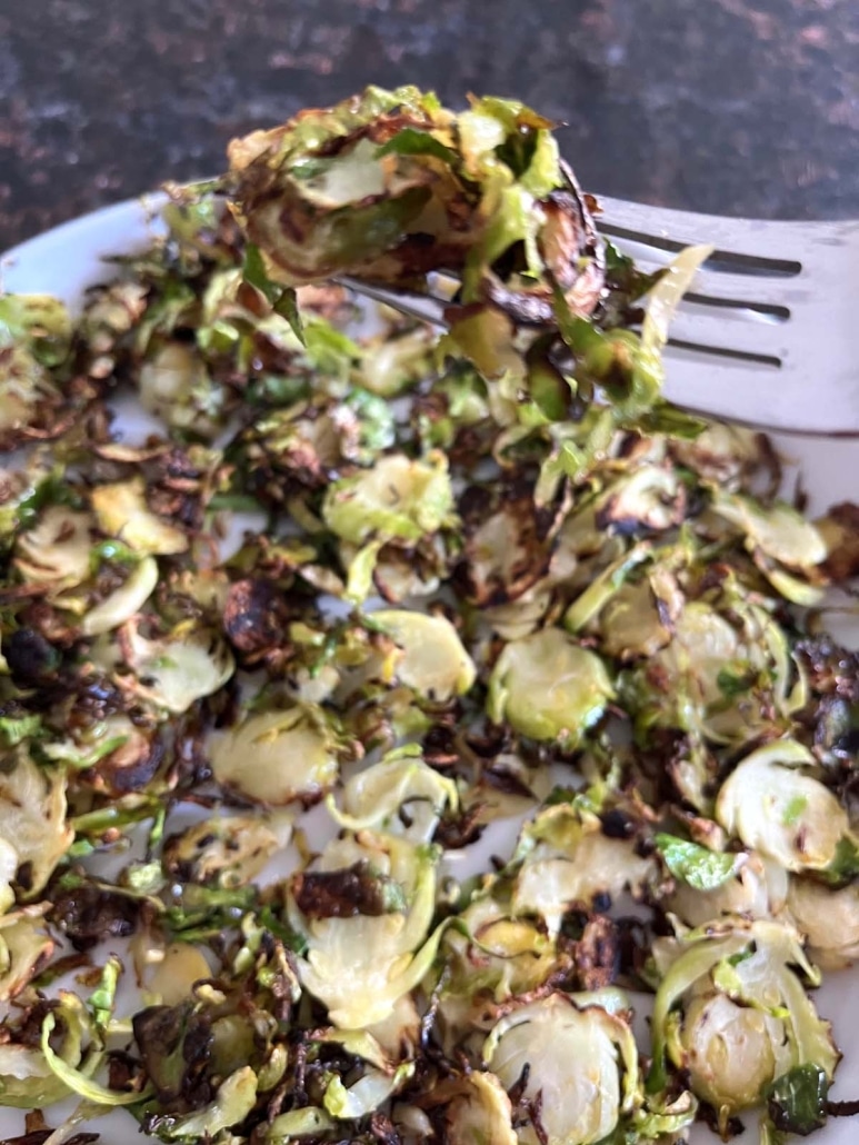 fork holding bite of Sauteed Shaved Brussels Sprouts