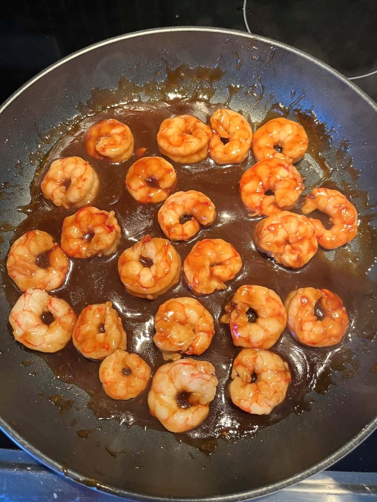 warm skillet with cooked teriyaki shrimp