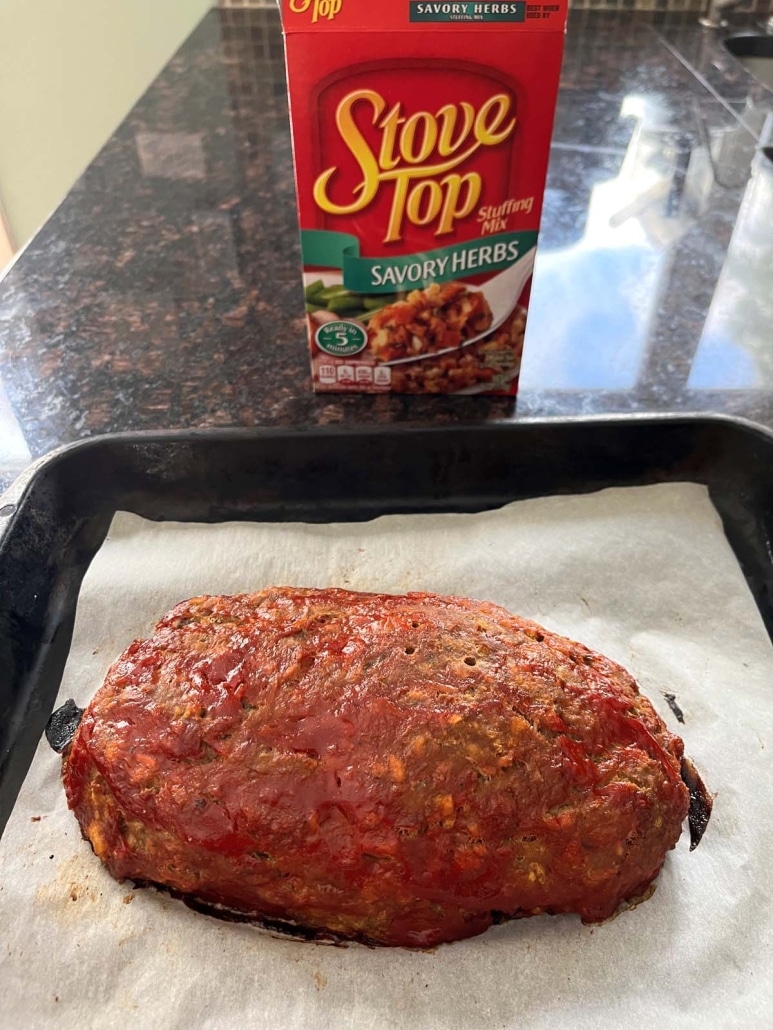 baked Stove Top Stuffing meatloaf next to a box of Stove Top stuffing mix