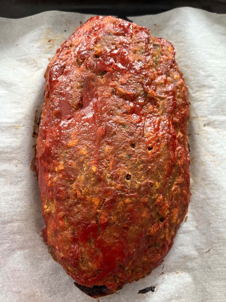 ketchup-covered meatloaf on a sheet pan