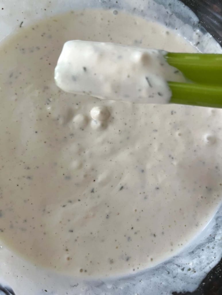 celery covered in creamy, homemade ranch dressing