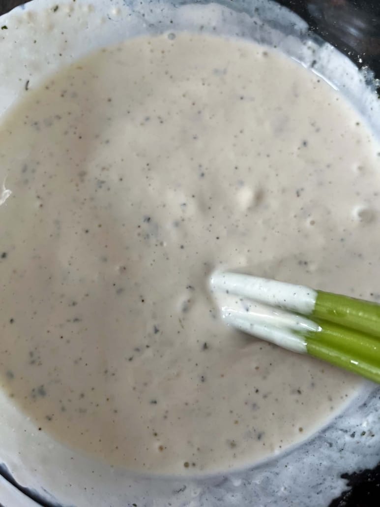 celery dipped in Wingstop Ranch Dressing Copycat Recipe