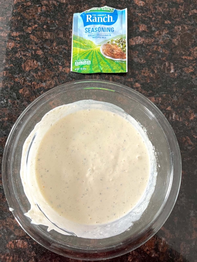 bowl of Wingstop Ranch Copycat Recipe next to a package of ranch dressing mix