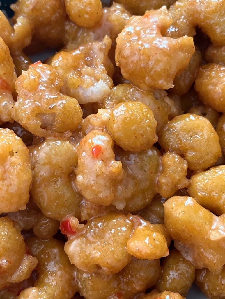 close-up of air fried shrimp coated in bang bang sauce